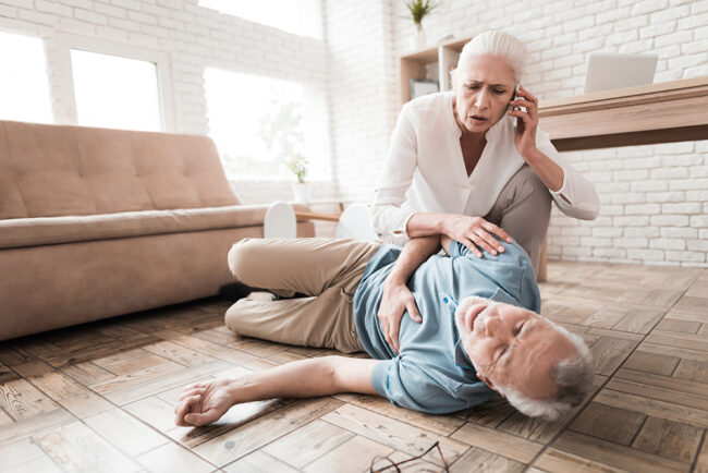 Agitated mature woman calls ambulance for elderly man.